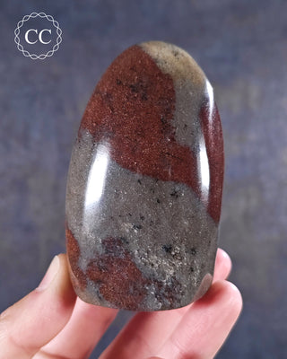 A hand holding a Hematite in Quartz Freeform from Madagascar