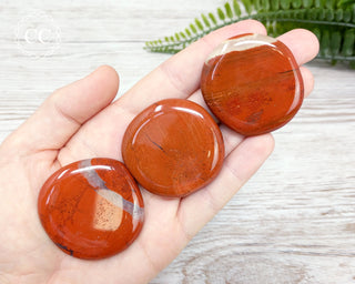 Red Jasper Palm stones in hand