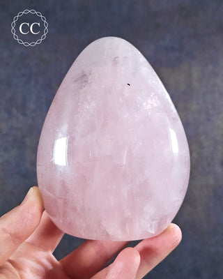 A hand holding a Rose Quartz Freeform from Madagascar