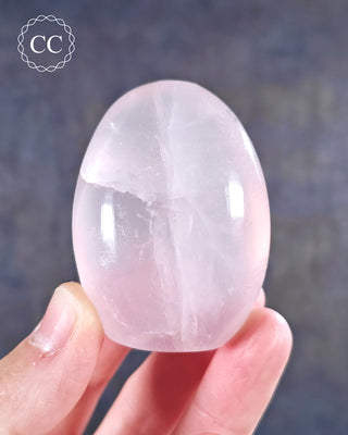 A hand holding a Rose Quartz Freeform from Madagascar 