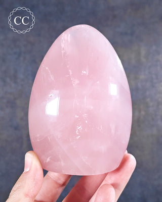 A hand holding a Rose Quartz Freeform from Madagascar 