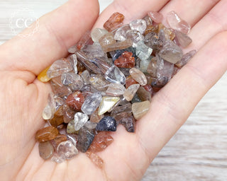 Rutilated Quartz Crystal Chips in hand