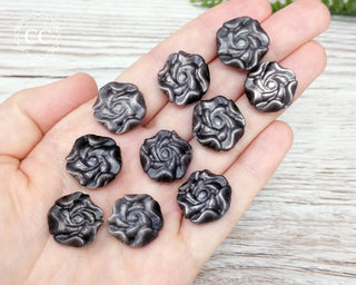 Silver Sheen Obsidian Rose crystals in hand