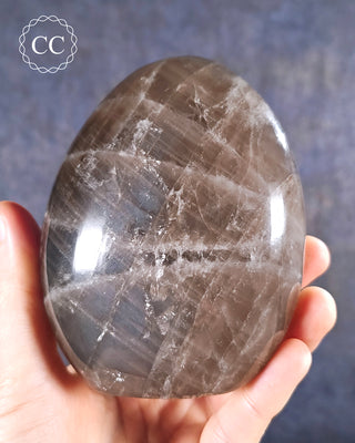 A hand holding a Smoky Quartz Freeform from Madagascar