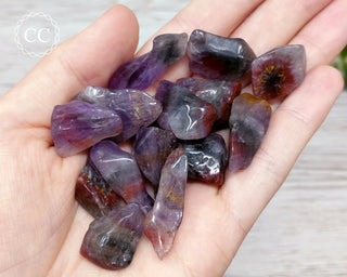 Super Seven Tumbled Crystals in hand