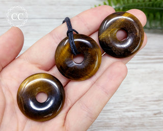 Tigers Eye Donut Necklaces in hand