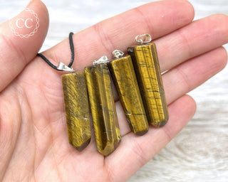 Tigers Eye Point Pendants in hand