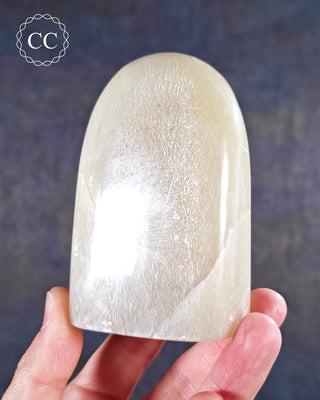 A hand holding a White Moonstone Freeform from Madagascar 