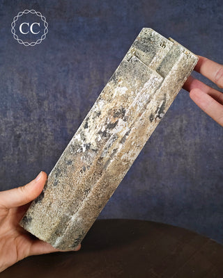 Two hands holding a large terminated Feldspar crystal with UV reactive Hyalite from Namibia 