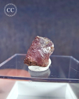 A Zultanite Crystal from Turkey displayed on a clear display box 
