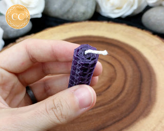 Mini Purple Rolled Beeswax Candle on wooden background