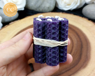 Mini Purple Rolled Beeswax Candles on wooden background