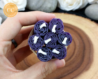 Mini Purple Rolled Beeswax Candles on wooden background