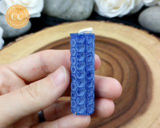Mini Blue rolled Beeswax Spell Candle on wooden background 