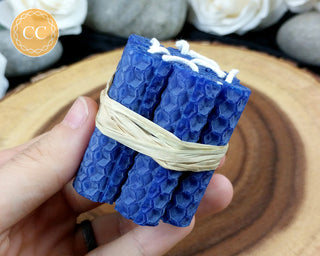 Mini Blue rolled Beeswax Spell Candle on wooden background 