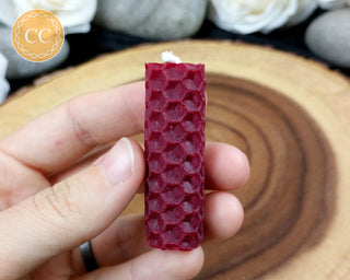 Mini Burgundy Rolled Beeswax Candle on wooden background