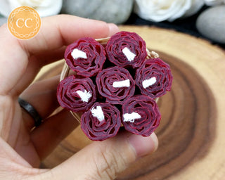 Mini Burgundy Rolled Beeswax Candles on wooden background