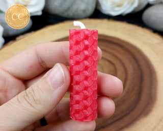 Mini Red Rolled Beeswax Candle on wooden background