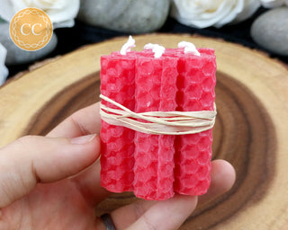 Mini Red Rolled Beeswax Candles on wooden background