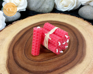 Mini Red Rolled Beeswax Candles on wooden background