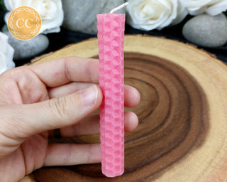 Pink Rolled Beeswax Candle on wooden background