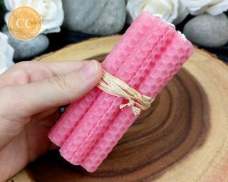 Pink Rolled Beeswax Candles on wooden background