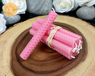 Pink Rolled Beeswax Candles on wooden background