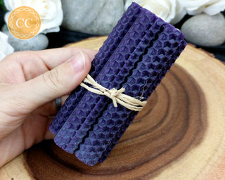 Purple Rolled Beeswax Candles on wooden background