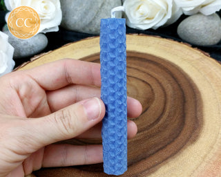 Blue Rolled Beeswax Candle on wooden background