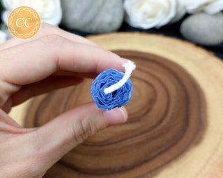 Blue Rolled Beeswax Candle on wooden background