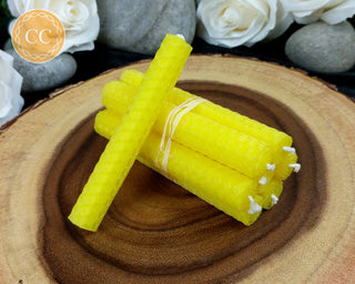 Yellow Rolled Beeswax Candles on wooden background
