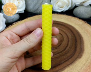 Yellow Rolled Beeswax Candle on wooden background