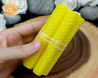 Yellow Rolled Beeswax Candles on wooden background